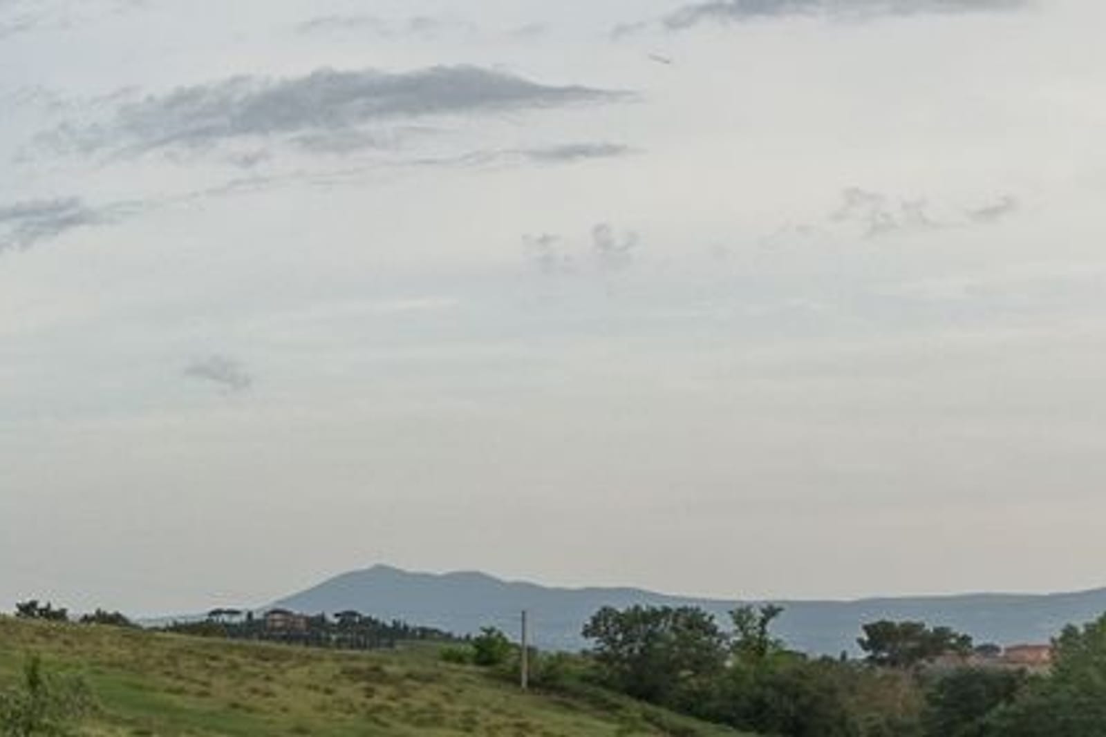 The Umbrian hills in winter haze, the outlines of the mountains behind