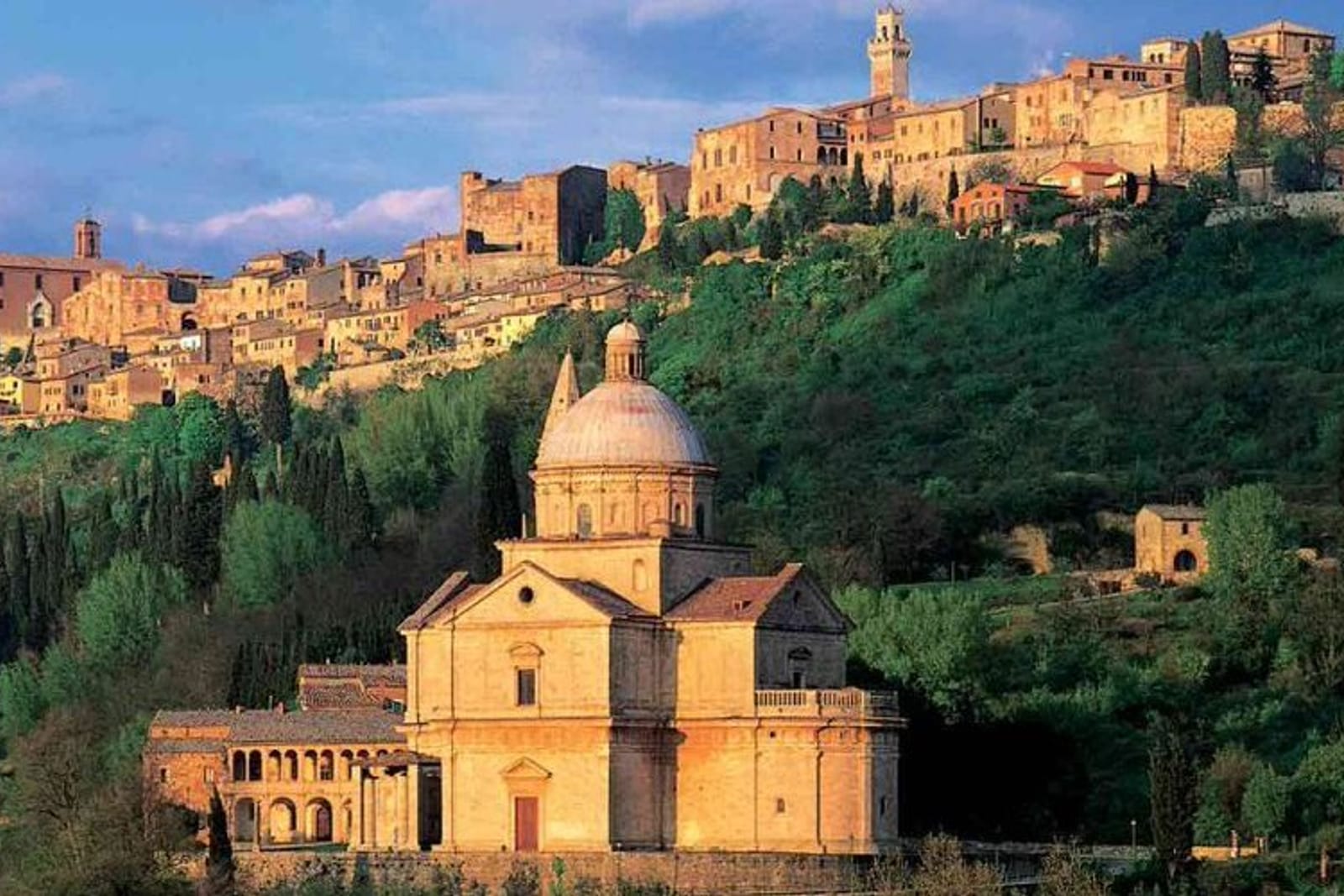The Temple of San Biagio standing alone on the meadow below Montepulciano, the town on the hill behind